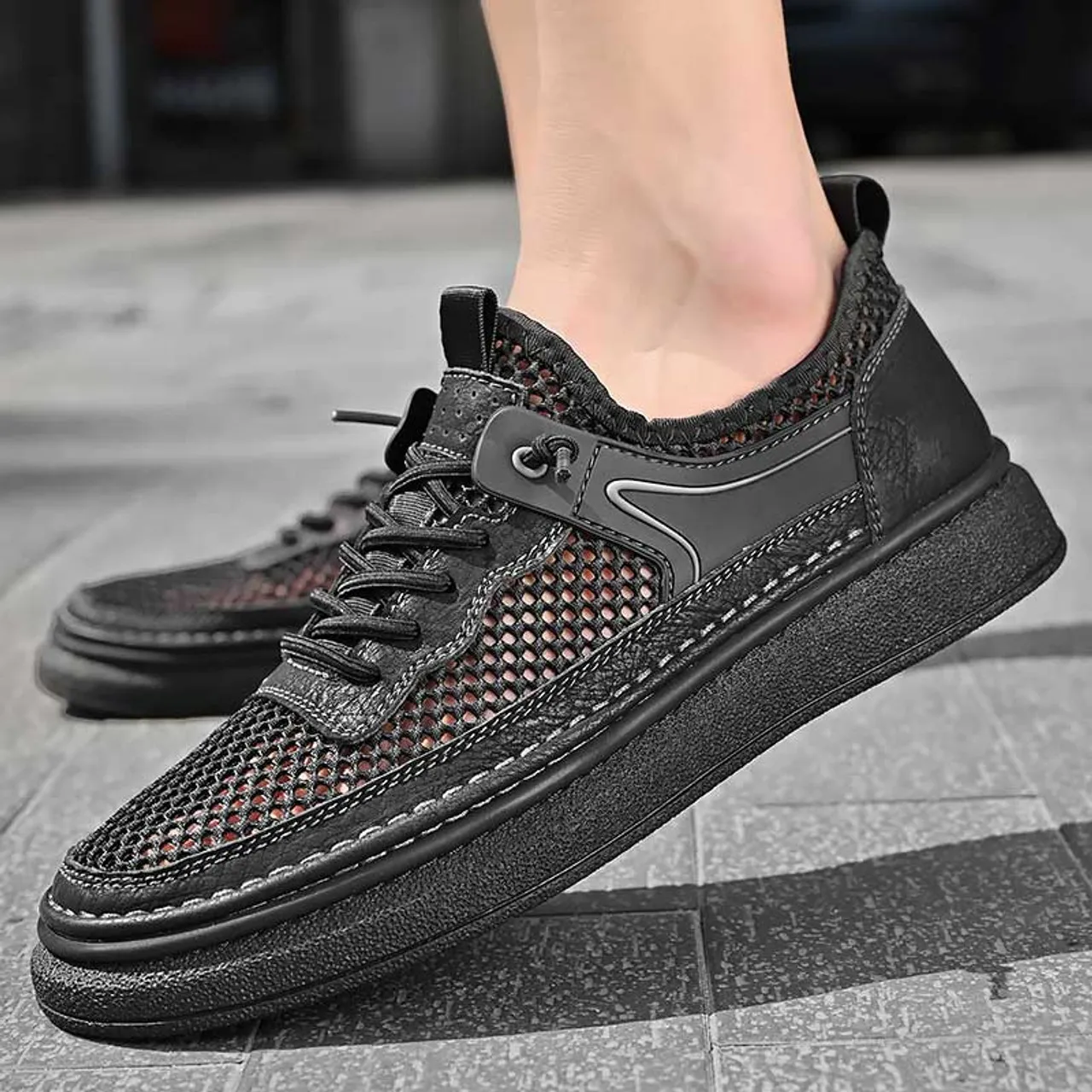 Black hollow mesh stitch accents shoe sneaker