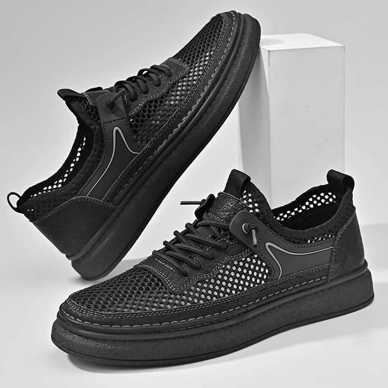 Black hollow mesh stitch accents shoe sneaker